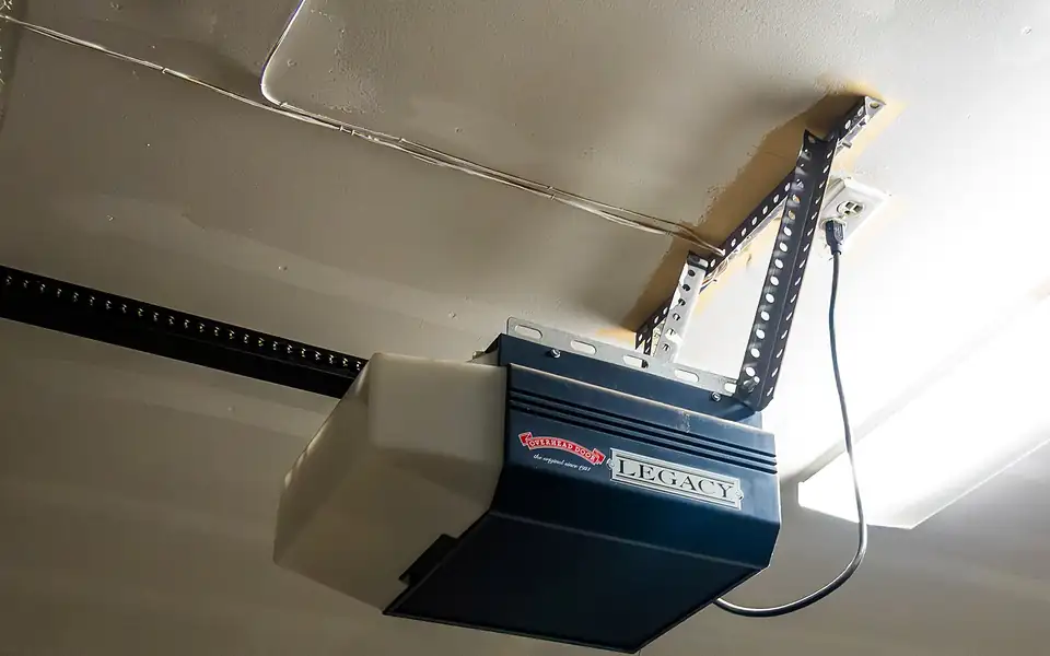 Belt-drive garage door opener mounted on a garage ceiling